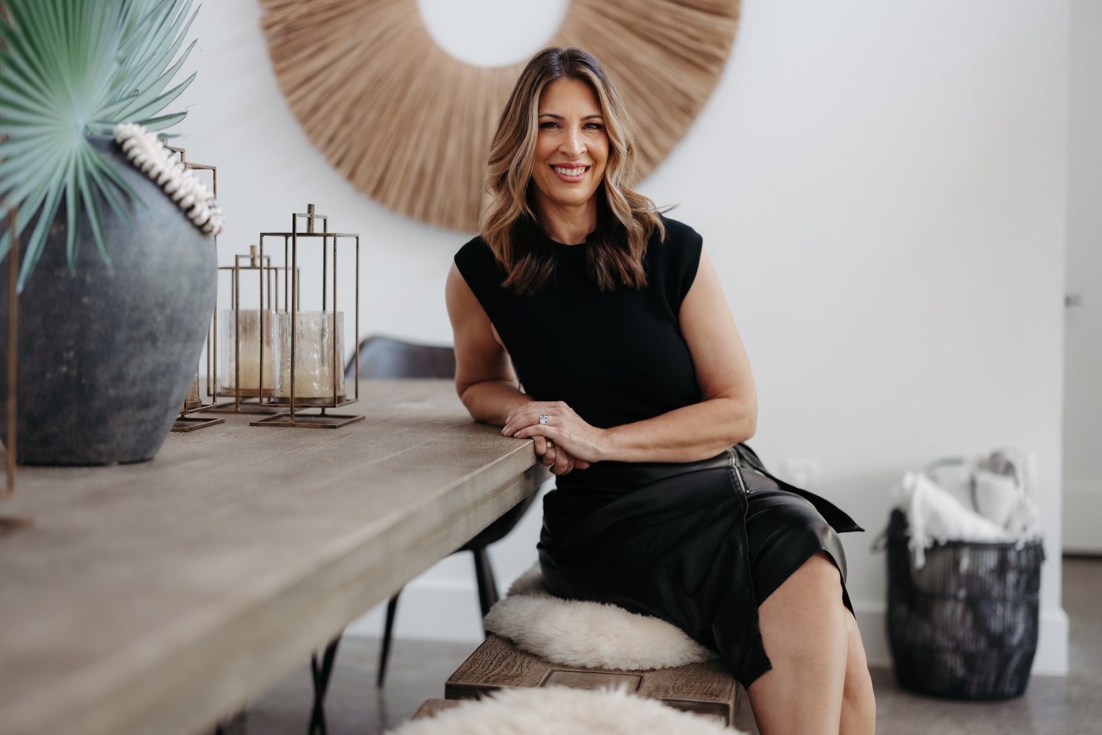 Elizabeth Riley seated by a woven wall